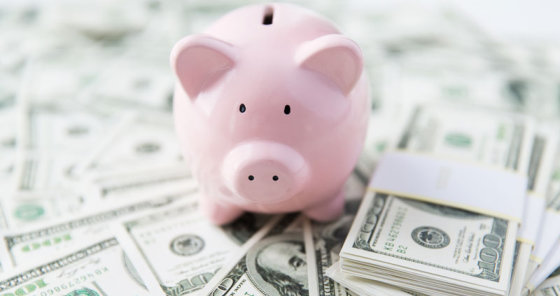 piggy bank with money lying around